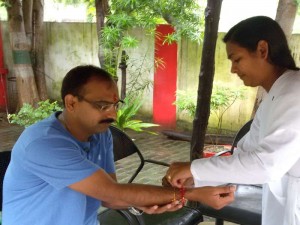B.K. Reena tying Rakhi to ASP Neeraj Pandey